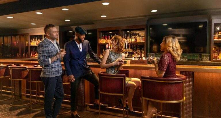 Four people socializing at a bar.